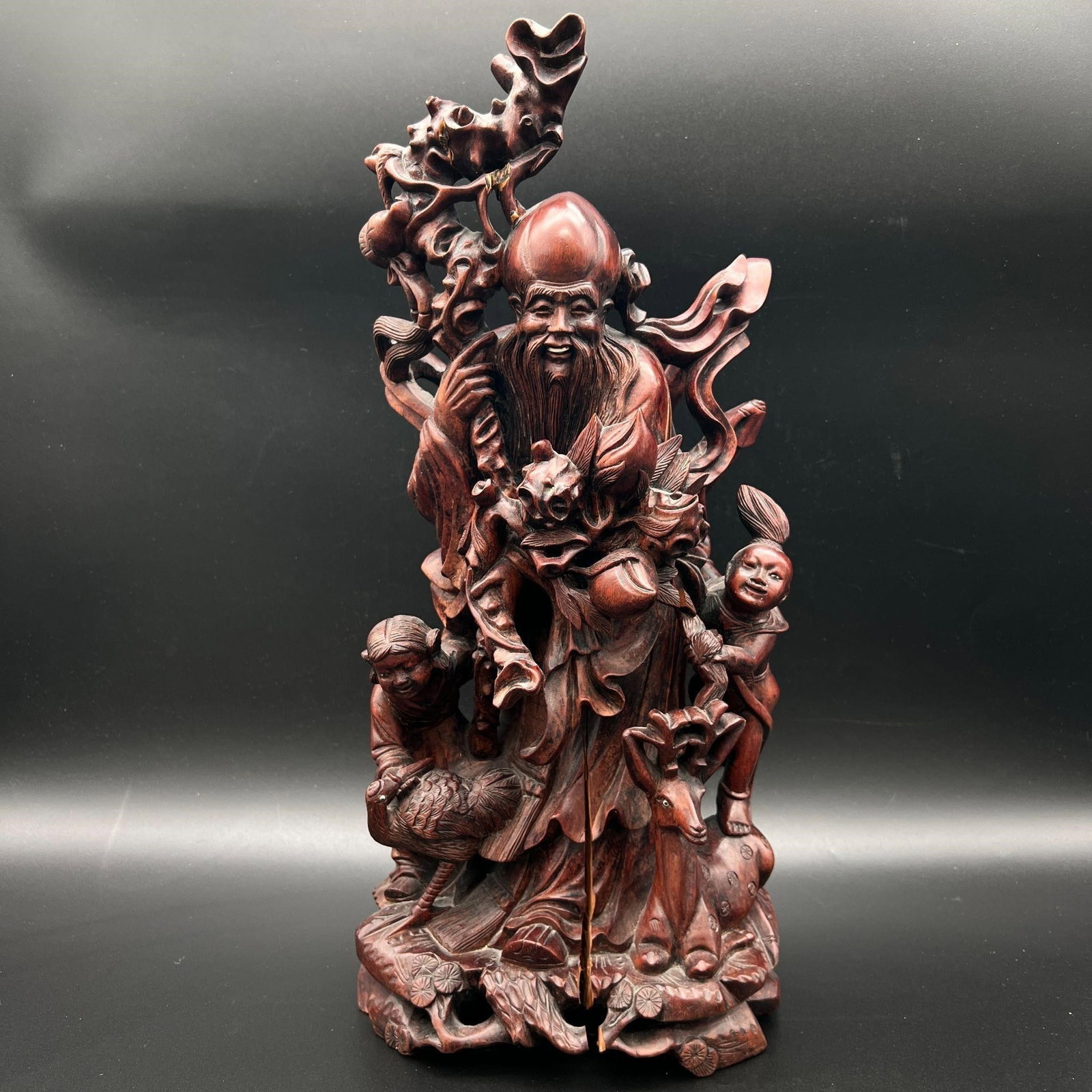 Chinese 'Shou Lao & Child' Carved Wooden Sculpture: Chinese 'Shou Lao & Child' Carved Wooden Sculpture. This piece is unsigned. There is a split in the wood starting at the base. Dimensions (in): 17 x 7.25 x 6.
