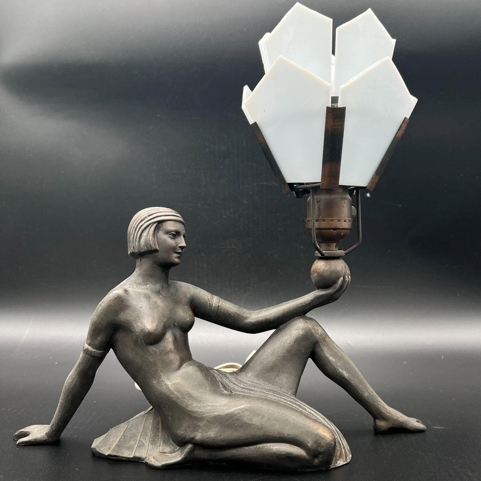 Art Deco Spelter Nude Woman Table Lamp: Art Deco Spelter Nude Woman Table Lamp. One glass panel is missing and there are few tiny nicks on the other glass panels. Dimensions (in): 13.25 x 13.25 x 5.