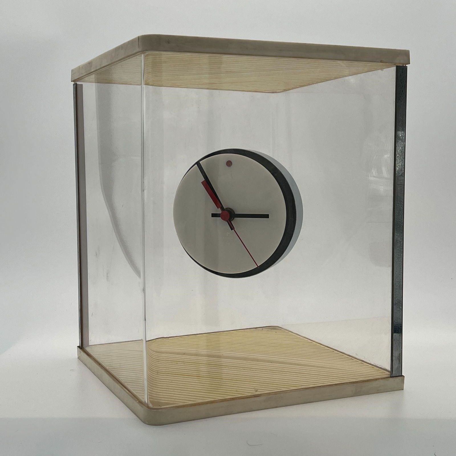 1960's Italian Lucite Mystery Clock by Raymor: 1960's Italian Lucite Mystery Clock by Raymor. A white lucite and chrome disk clock "floats" inside a ivory-colored plastic and lucite cube. By Raymor with battery-powered movement. Approx. Dimensions