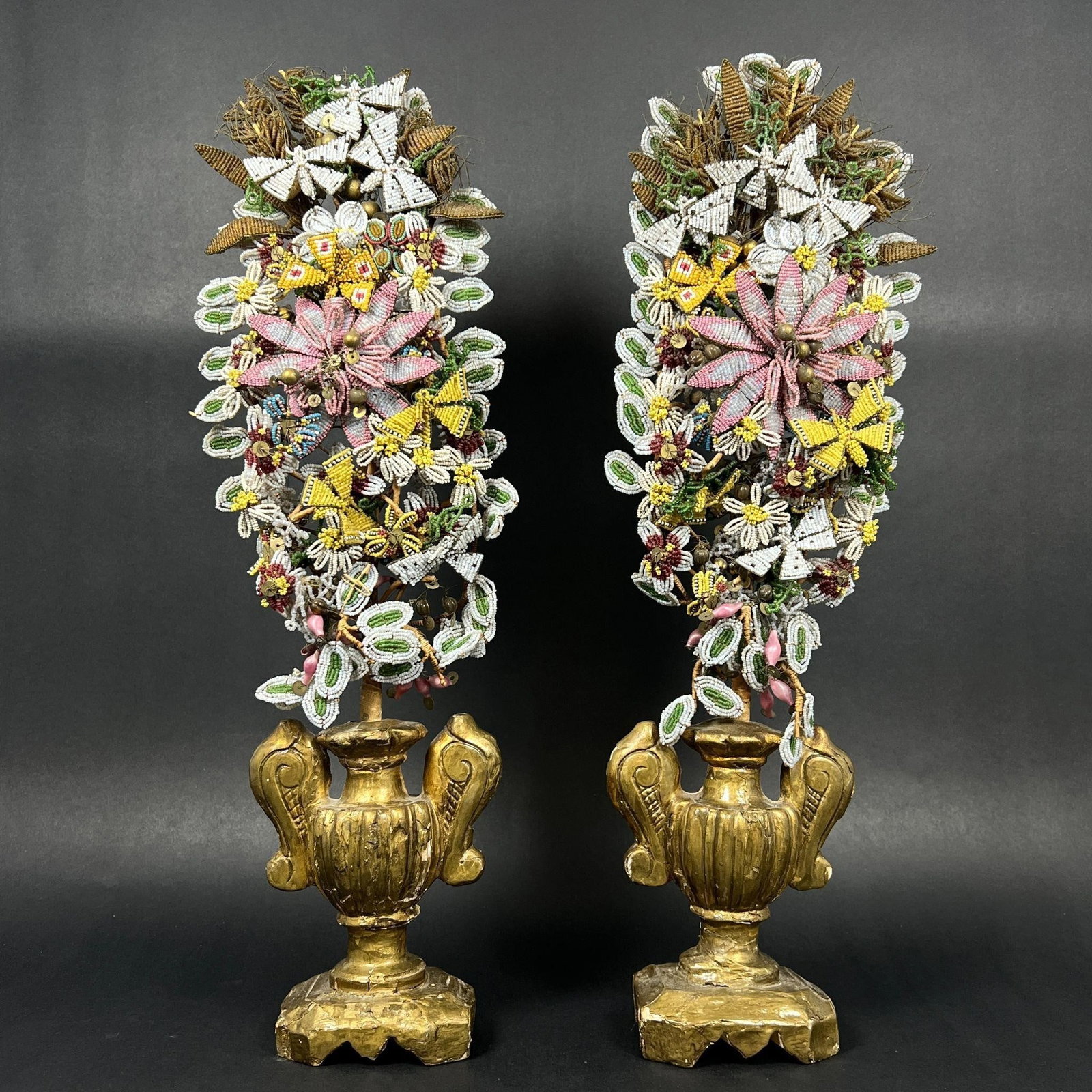 Pair Of Handmade Beaded Flowers Topiaries: Pair Of Handmade Beaded Flowers Topiaries. The finish is worn. Unsigned. Multiple chips and cracks on the base. Approx. Dimensions (in): 18 x 5.5 x 3.25.