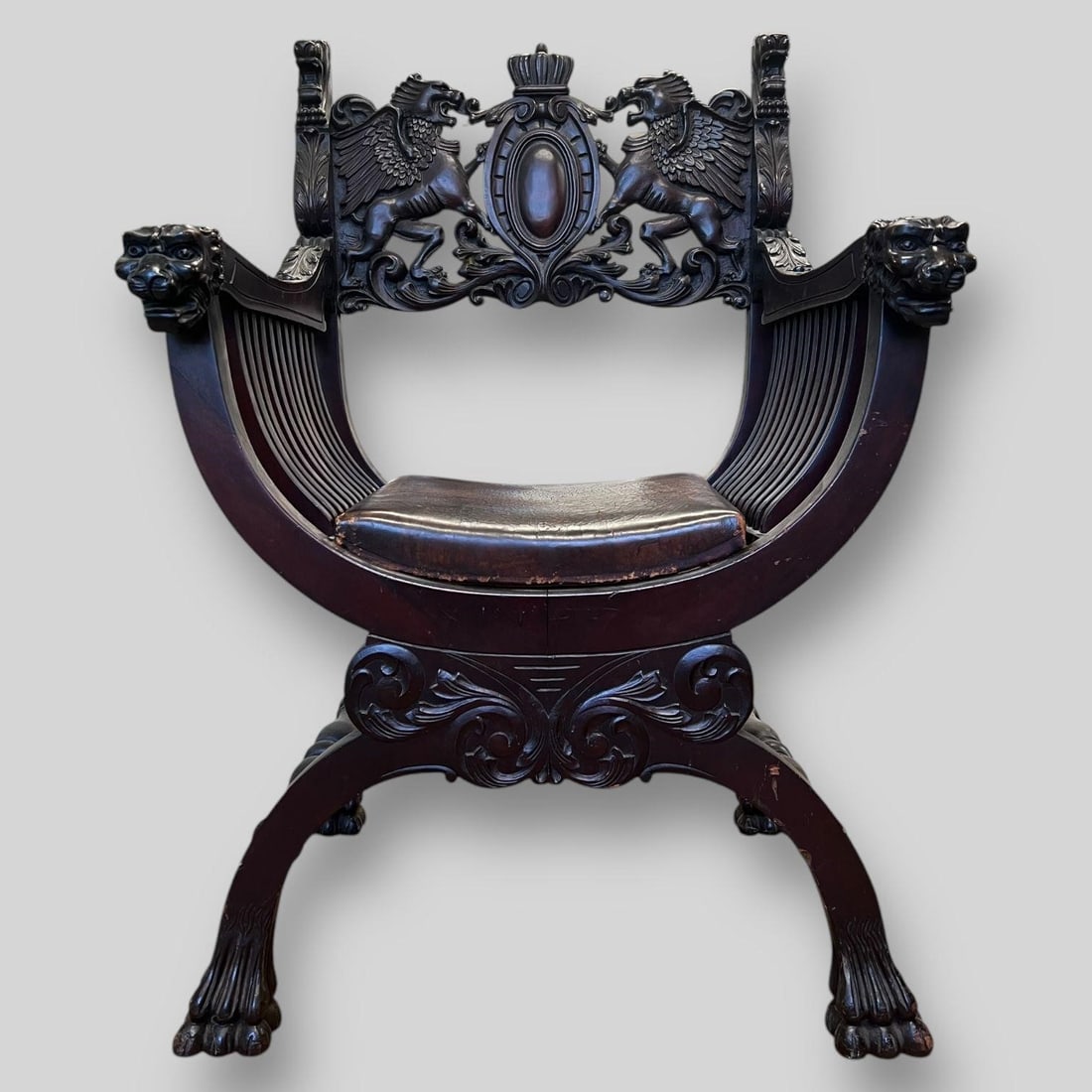Carved Wood Chair With Griffin Head Arms & Paw Fee: Carved Wood Chair With Griffin Head Arms & Paw Fee. There is some age / wear to the leather seat. Approx. Dimensions (in): 40.25 x 24.5 x 21.5.