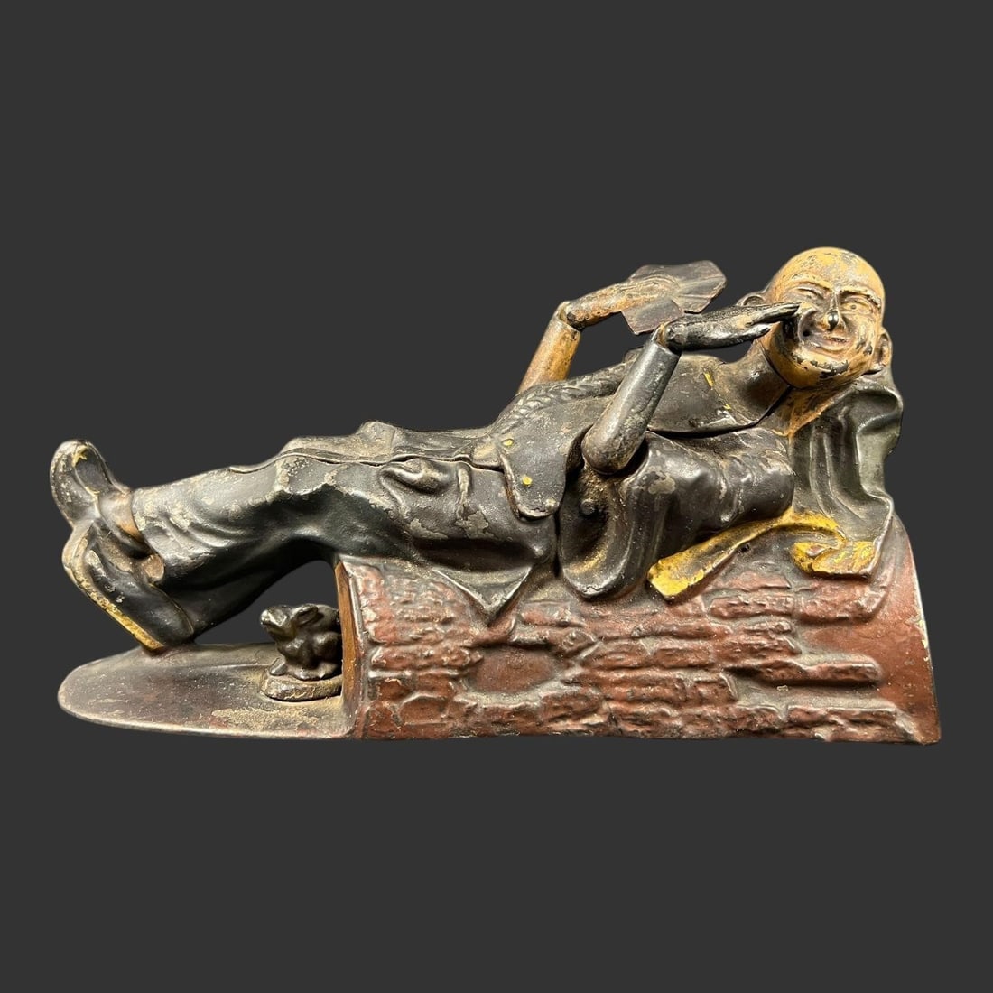 Reclining Chinaman Cast Iron Mechanical Bank: Reclining Chinaman Cast Iron Mechanical Bank. Approx. Dimensions (in): 4.5 x 8.25 x 2.5. There is some wear to the original finish. Patent number 1882 on the bottom.