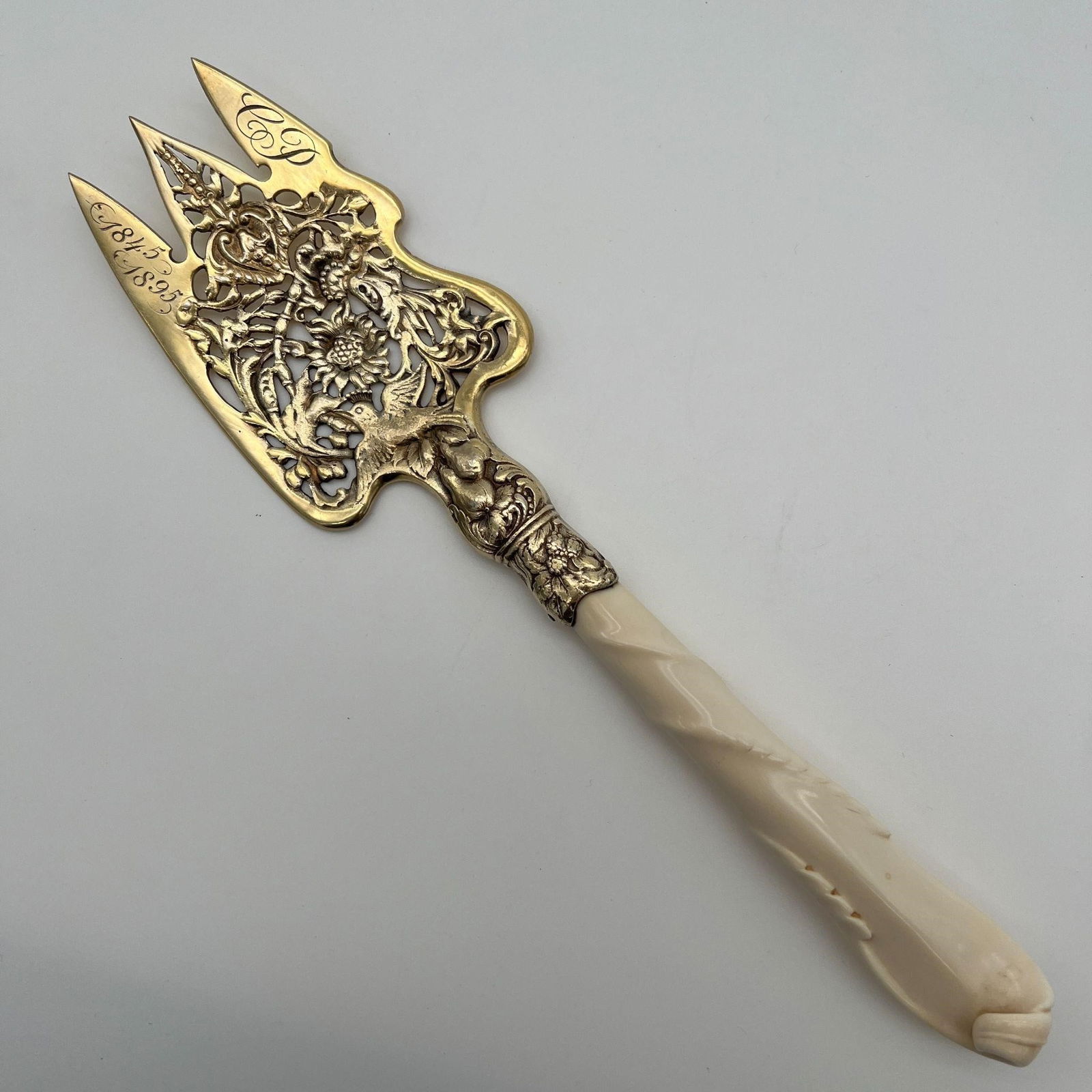 1845-1895 Sterling Silver Fish Serving Fork: 1845-1895 Sterling Silver Fish Serving Fork. Gorham Manufacture, fish serving fork. Carved bone handle. Marked on the back. Floral design with birds. Monogrammed 'CP.' Approx. Length (in): 10.