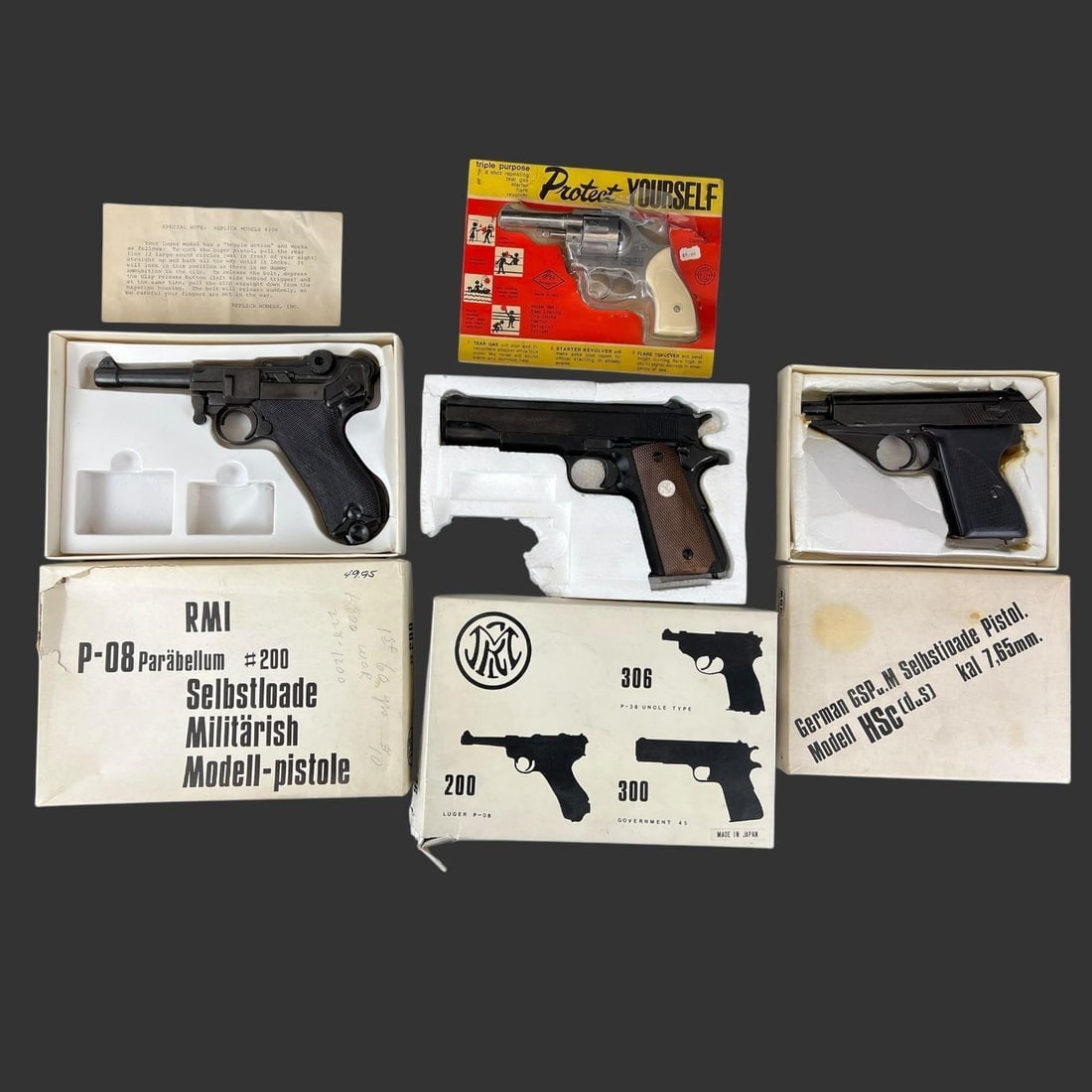 Lot of 4 Replica Model Pistol Handguns: Lot of 4 Replica Model Pistol Handguns. This lot includes four non-firing replica guns. Mondial Triple Purpose Revolver, P-08 Luger #200, Government 45 #300, & Mauser HSc. Approximate Biggest Piece Le