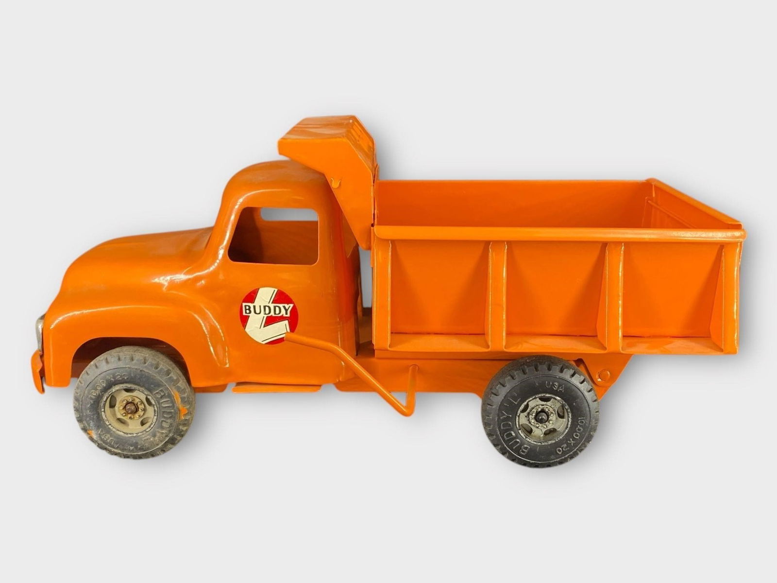 Buddy L Pressed Steel Orange Dump Truck: Buddy L Pressed Steel Orange Dump Truck . Orange. Approx. Dimensions (in): 13.5 x 6.5 x 5.5