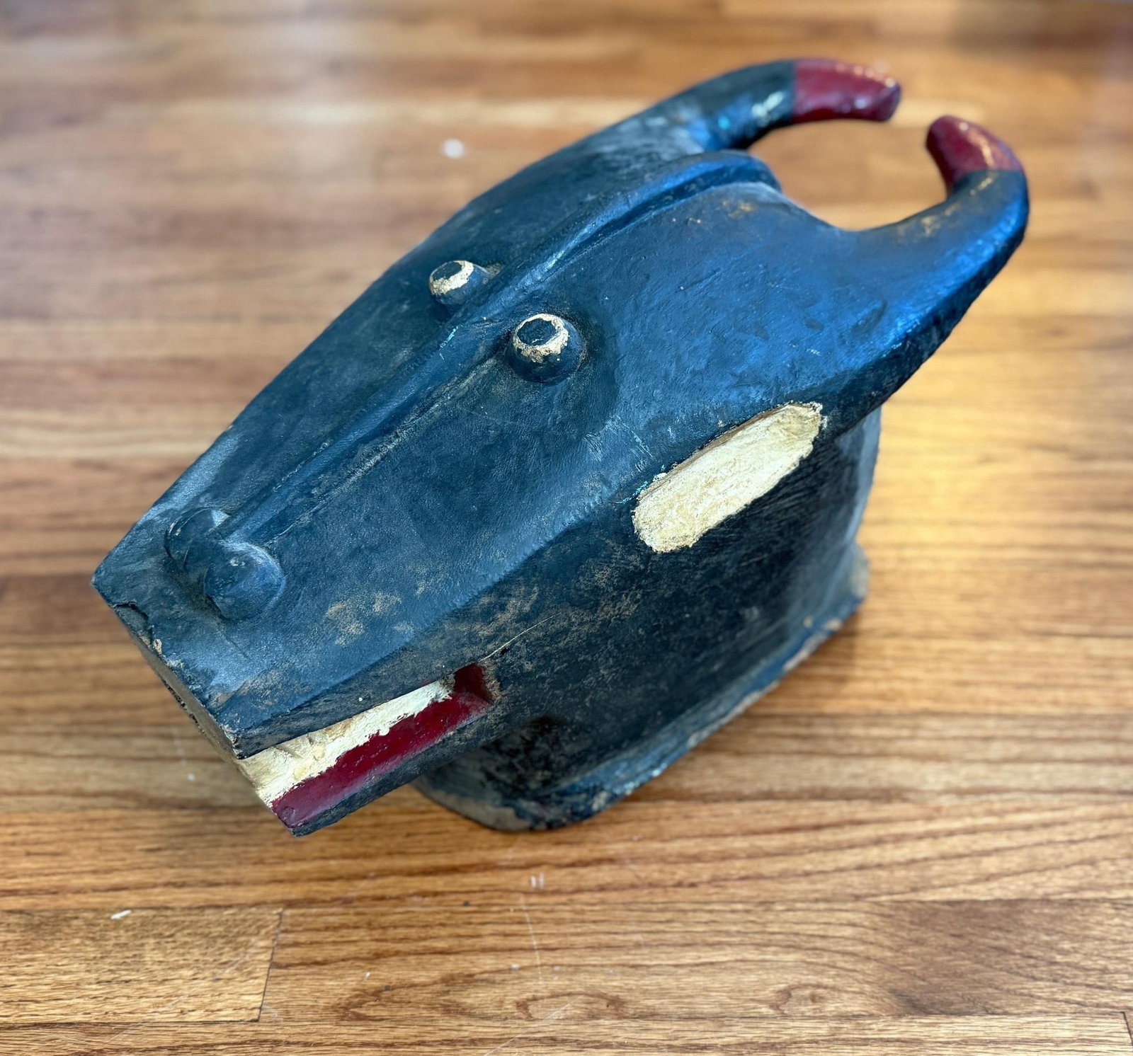 Large Carved Wood African Baule Buffalo Mask: There is a crack to the back of the mask. This piece is most likely from the Baule people of the Ivory Coast. Approx. Dimensions (in): 23 x 11 x 9.