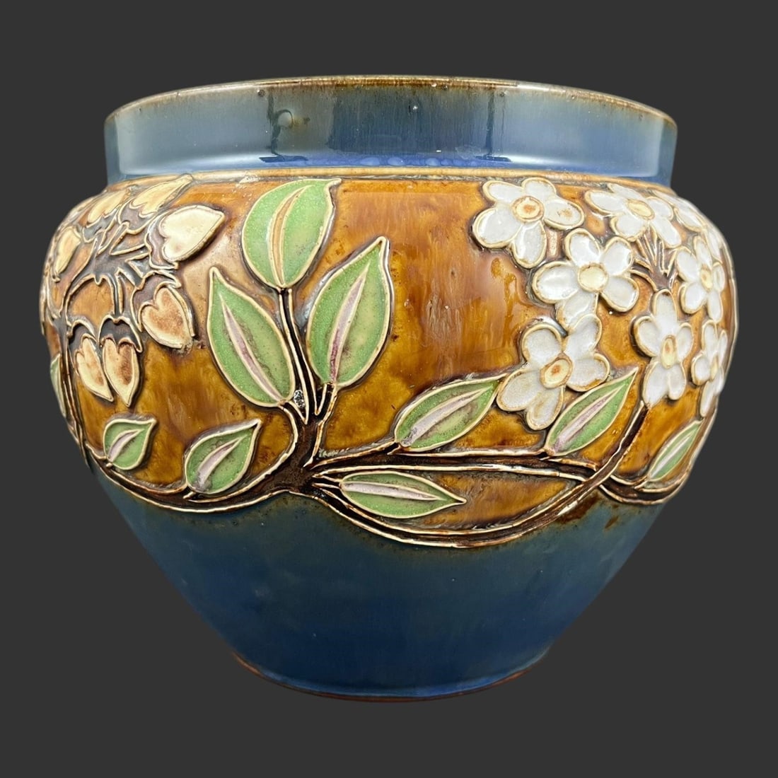 Royal Doulton England Pottery Jardinière Planter: Raised floral design. Signed on the bottom of the planter. #8300. Approx. Dimensions (in): 7.25 x 7.5 x 7.5.