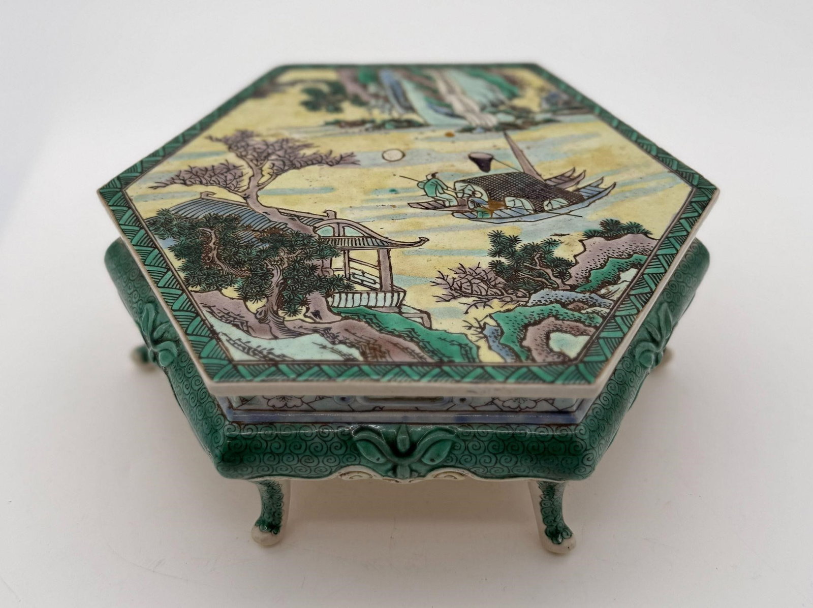 Asian Porcelain Famille Verte Hexagonal Stand: This piece is not signed. This piece most likely dates to the Qing Dynasty. Approx. Dimensions (in): 8 x 7 x 3.1.