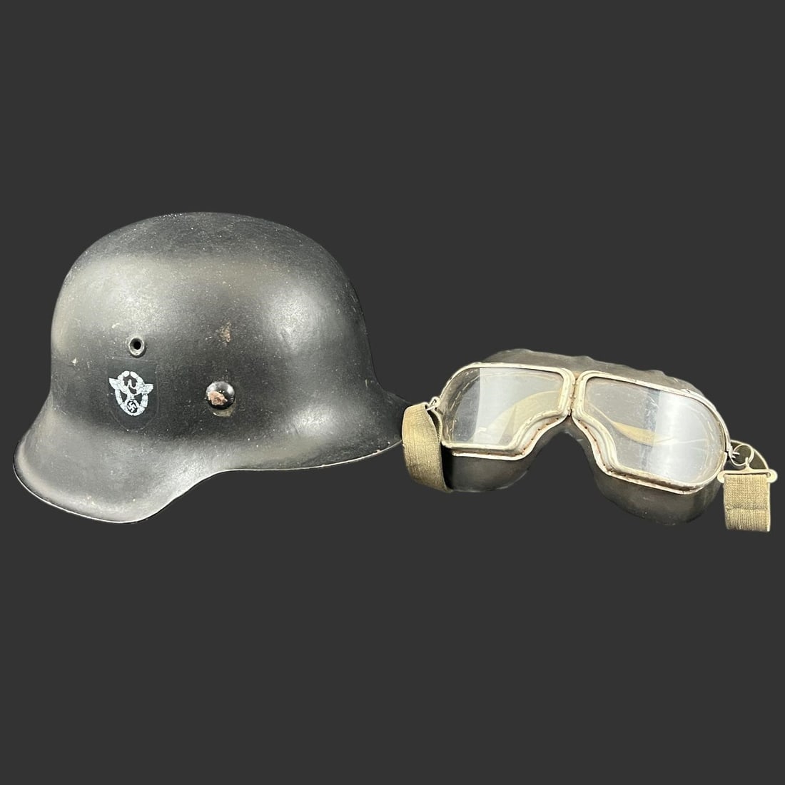 WW2 Nazi Germany Stahlhelm Helmet w/ Goggles: WW2 Nazi Germany Stahlhelm Helmet w/ Goggles. Known colloquially as the "coal scuttle" helmet due to its flared neck guard and visor, designed to offer superior protection to the sides and back of the