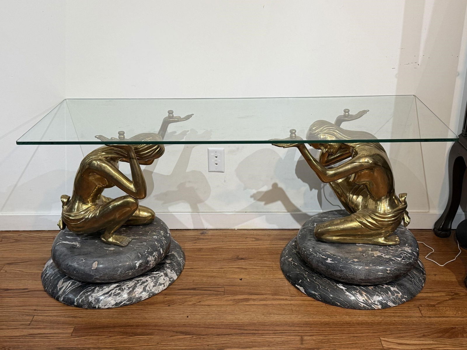 Coffee Table with Bronze Nymph Sculpture Base: Coffee Table with Bronze Nymph Sculpture Base. Art Deco console table with figural bronze nude ladies' design, supporting a glass tabletop. This style often evokes a sense of classical or Art Deco aes