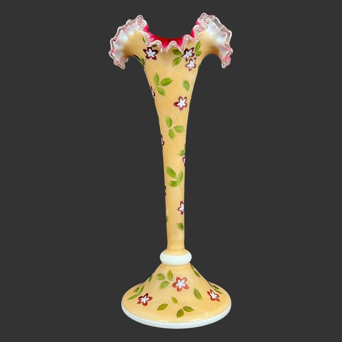 Opaline Glass Fluted Floral Trumpet Vase: The vase features a tall, slender "trumpet" shape with a wide, ruffled rim and a stable, flared base. The vase is made of yellow opaline glass and features a hand-painted enameled floral design. The e