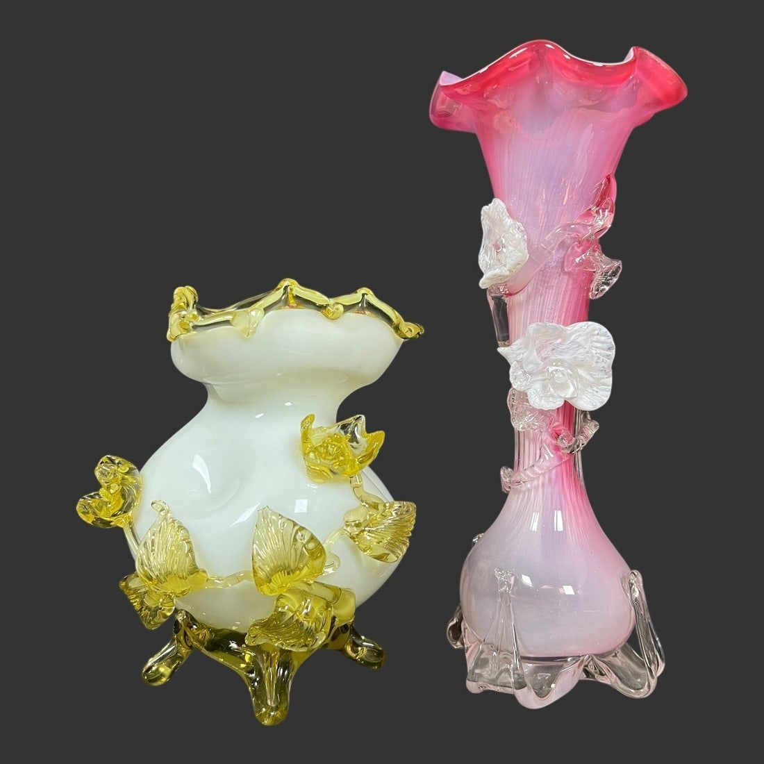 Lot of 2 Art Glass Applied Floral Vases: These two pieces are examples of Victorian art glass, specifically known for the "applied" glass decoration, where glass pieces are added to the surface of the main vessel. The vase on the left is a "