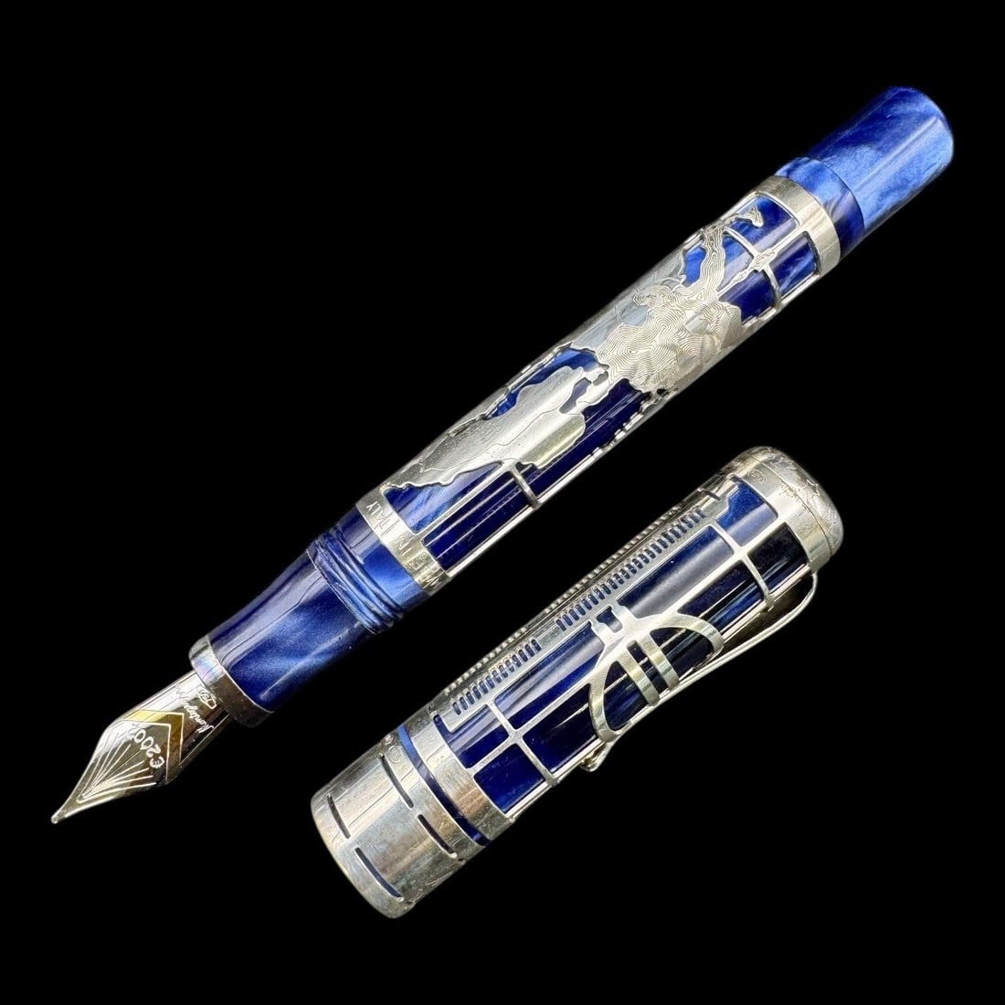 Montegrappa Euro 2002 Limited Edition Fountain Pen: This limited-edition pen was created to celebrate the adoption of the Euro currency in 2002. The pen features a sterling silver overlay with a filigree design over a blue resin body. The design includ