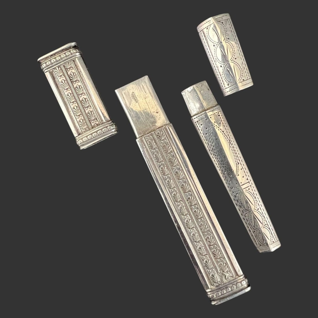 Lot of 2 Antique Silver Etuis or Needle Cases: These items are antique silver etuis or needle cases, which are small, highly decorated portable cases for holding items like sewing needles, bodkins (blunt needles for threading ribbon), or pencils.