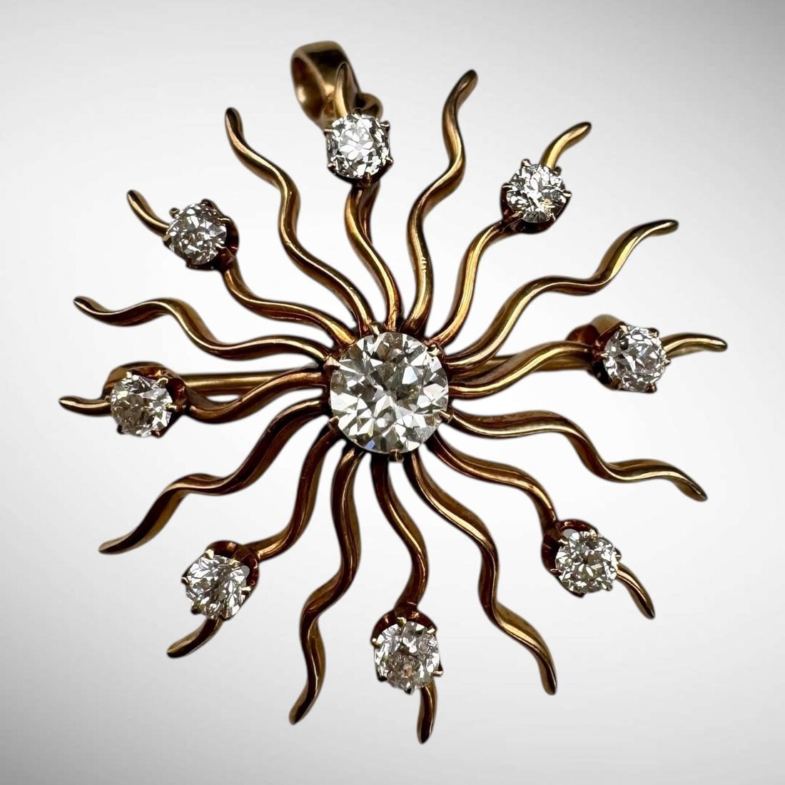 Victorian 14K Gold Diamond Sunburst Brooch/Pendant: Features nine old mine cut diamonds, approximate total diamond weight is 0.75ct. Tested and guaranteed to be 14K. Approx. dimensions (in): 1.25. Weight: 5.8 grams. It is the Buyer's responsibility to