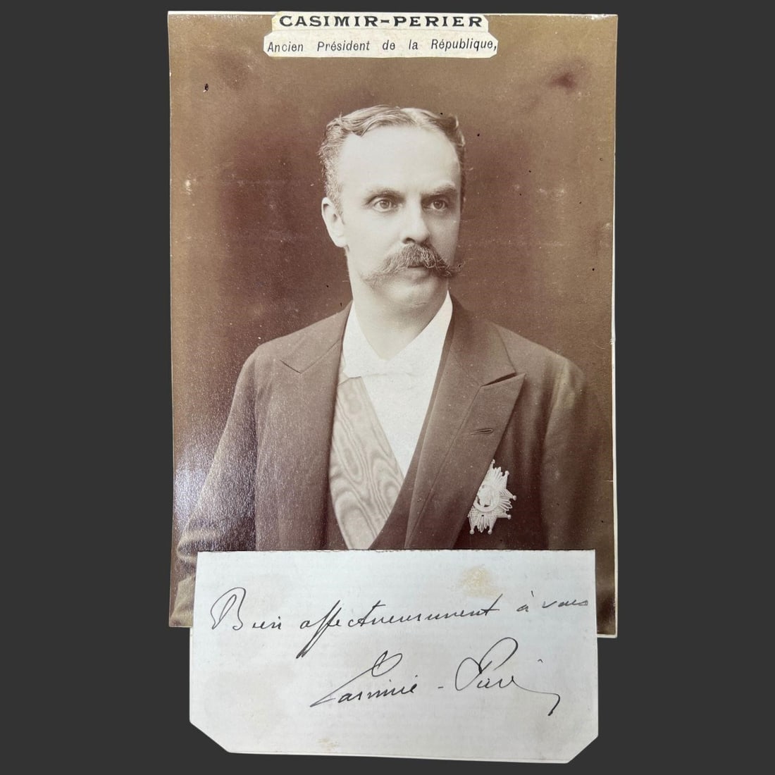 Jean Casimir-Perier (1847-1907) Signed Note: Clipped autograph note signed: "Casimir-Perier." The sepia cabinet-style photograph shows him in formal attire with decorations, presenting a dignified and imposing statesman's likeness. Beneath the p