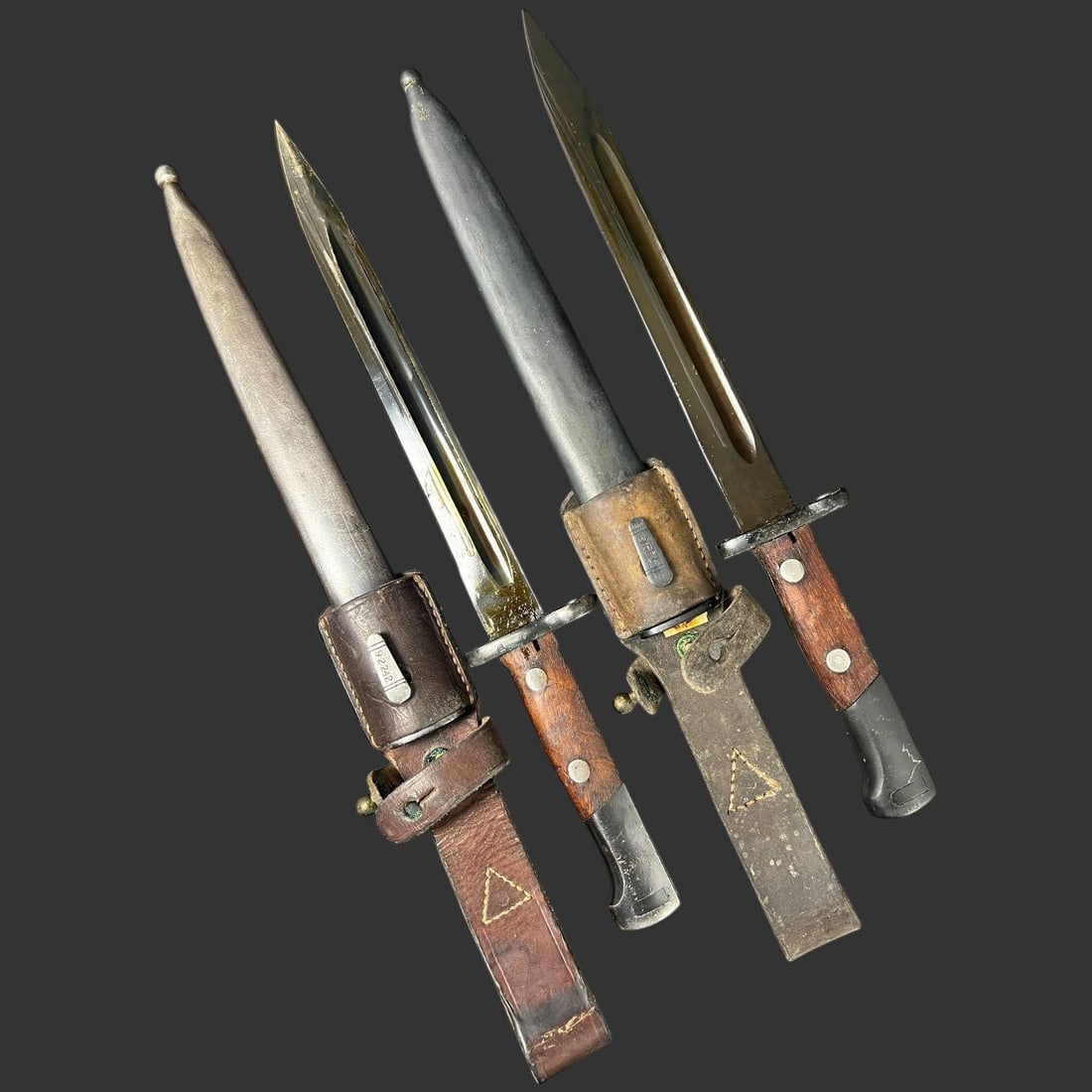 Two 1936 Yugoslavian Model 1924 Mauser Bayonets: This matched pair of bayonets represents the classic Yugoslavian Model 1924 Mauser bayonet, both dated 1936 and bearing clear factory Cyrillic markings. Each example shows the distinctive Yugoslav ref