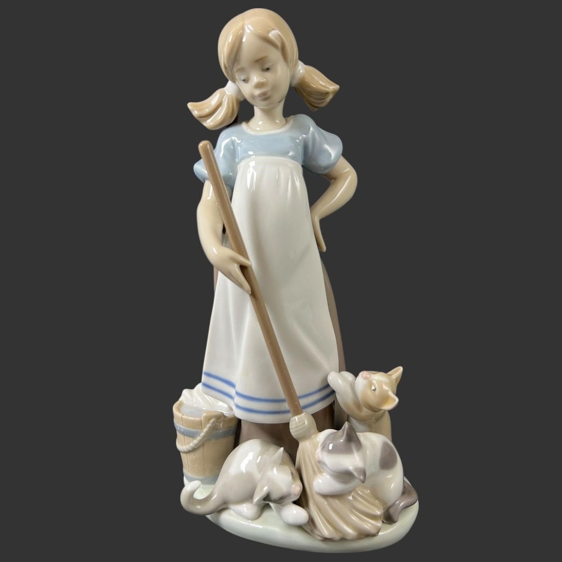 Lladro Spain Porcelain #5232 'Playful Kittens': This charming Lladro porcelain figurine depicts a young girl gently sweeping while surrounded by playful kittens, a classic example of the brand's sentimental and finely modeled style. The figure is r