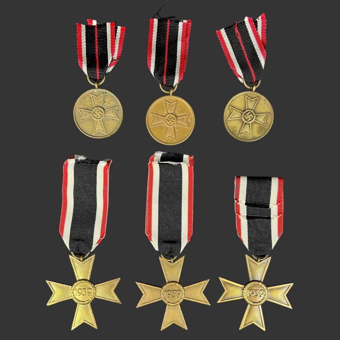 German WWII War Merit Medal & Cross Group (6): This lot consists of six German WWII-era decorations from the War Merit series, comprising three War Merit Medals and three War Merit Crosses, all dated 1939. The round medals are inscribed "Für Krie