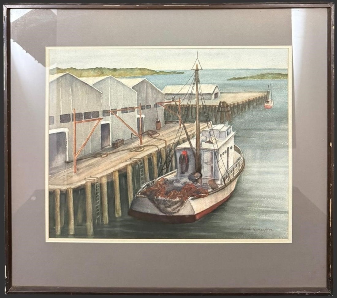 Alice Schaeffer Signed Harbor Scene Watercolor: Original watercolor by Alice Schaeffer depicting a quiet working harbor with a fishing vessel moored alongside a wooden pier and long warehouse buildings extending over calm coastal waters. Executed i