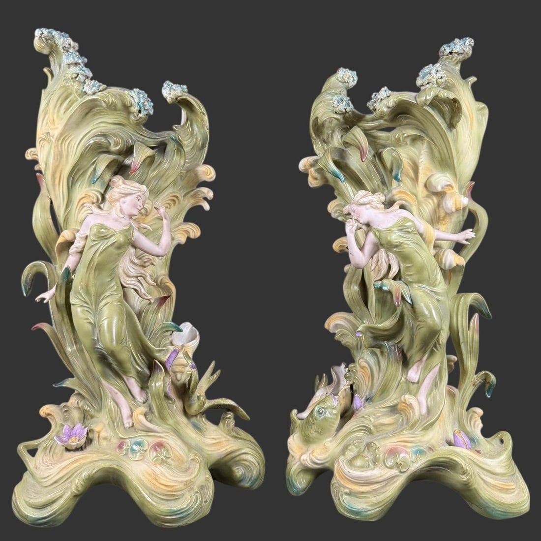 Large Art Nouveau Figural Vases, Royal Dux Germany: Striking pair of large Art Nouveau figural ceramic vases attributed to Royal Dux, Germany, each modeled as a flowing female figure emerging from sinuous foliate and aquatic forms, accented with irides