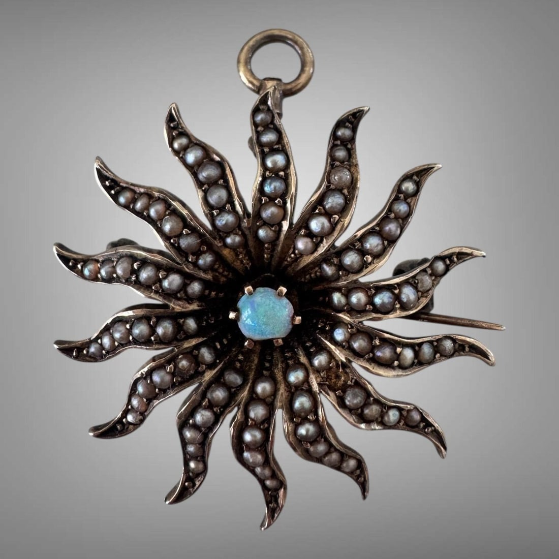 Antique 14K Gold Opal Seed Pearl Sunburst Pendant: Antique brooch/pendant from Victorian or Edwardian era featuring sunburst or starburst motif. Tested and guaranteed to be 14K yellow gold. Foldable bail and c-clasp pin in the back. Good condition, no