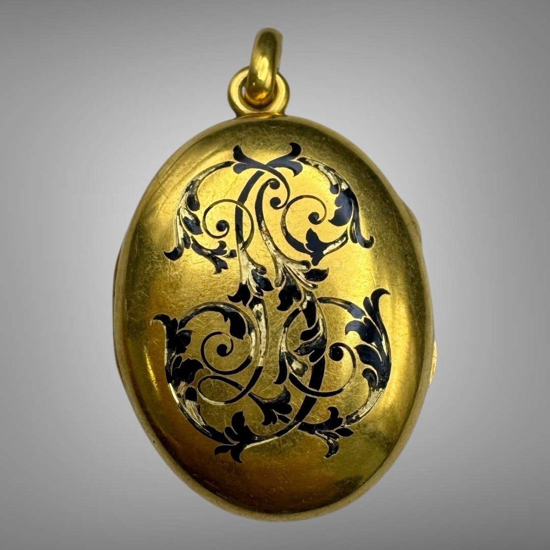 Antique Victorian 14K Gold Mourning Locket Pendant: The oval hinged, civil war era locket opens to reveal a lock of hair in a swirl design under a glass on one side, and a faded photograph of a person on the other. Front side of the locket is adorned w