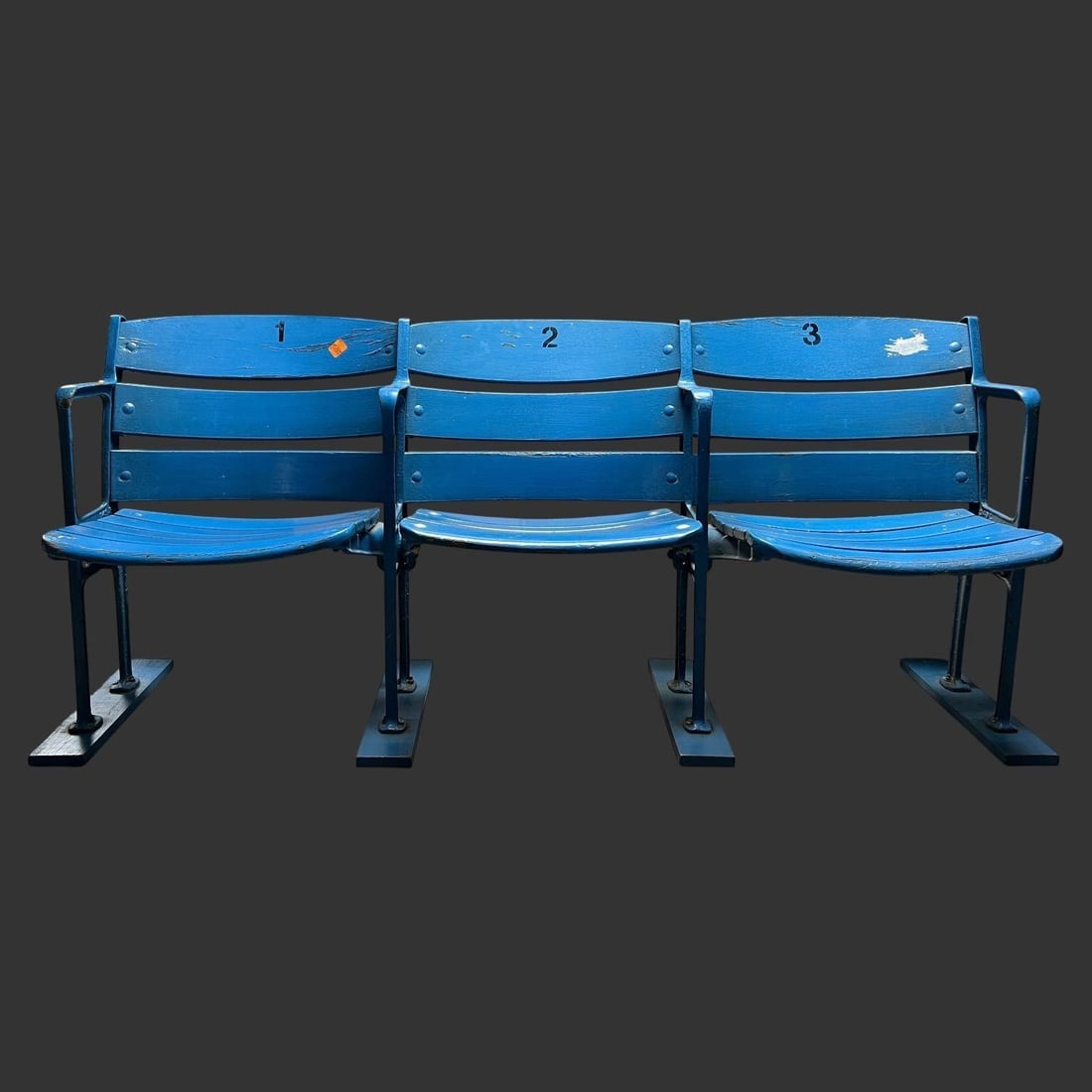 Vintage Three-Seat Yankee Stadium Bench: Vintage three-seat stadium bench constructed of painted wood slats with heavy cast-iron supports, retaining its original blue paint and stenciled seat numbers "1," "2," and "3" on the backrests. This