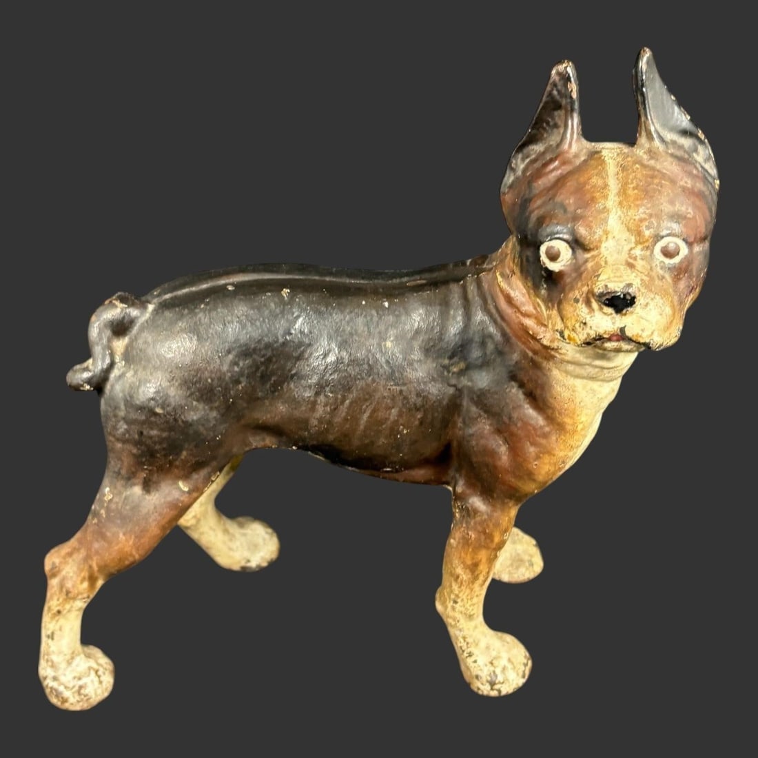 Cast Iron Bulldog Boxer Dog Doorstop Figure: Antique cast iron dog doorstop or figural sculpture depicting a standing bulldog or boxer with cropped ears and expressive glass eyes, finished in original hand-painted polychrome with rich surface pa