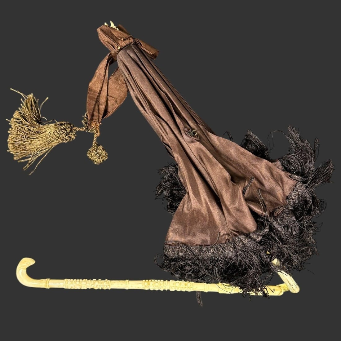 Victorian Carved Handle Umbrella Parasol: Elegant antique Victorian parasol featuring a richly carved handle and shaft with detailed floral and foliate ornamentation, terminating in a gracefully curved crook handle. The canopy is fashioned fr