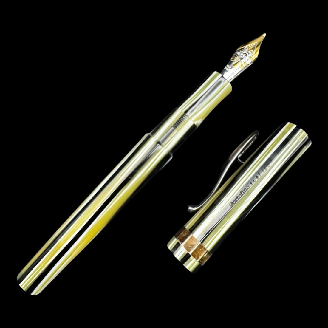 Visconti 18k 'Portofino' Fountain Pen: Visconti Portofino fountain pen featuring a translucent resin body in clear and yellow tones with polished metal trim and a sculpted Visconti clip. The pen is fitted with an engraved 18k (750) gold ni