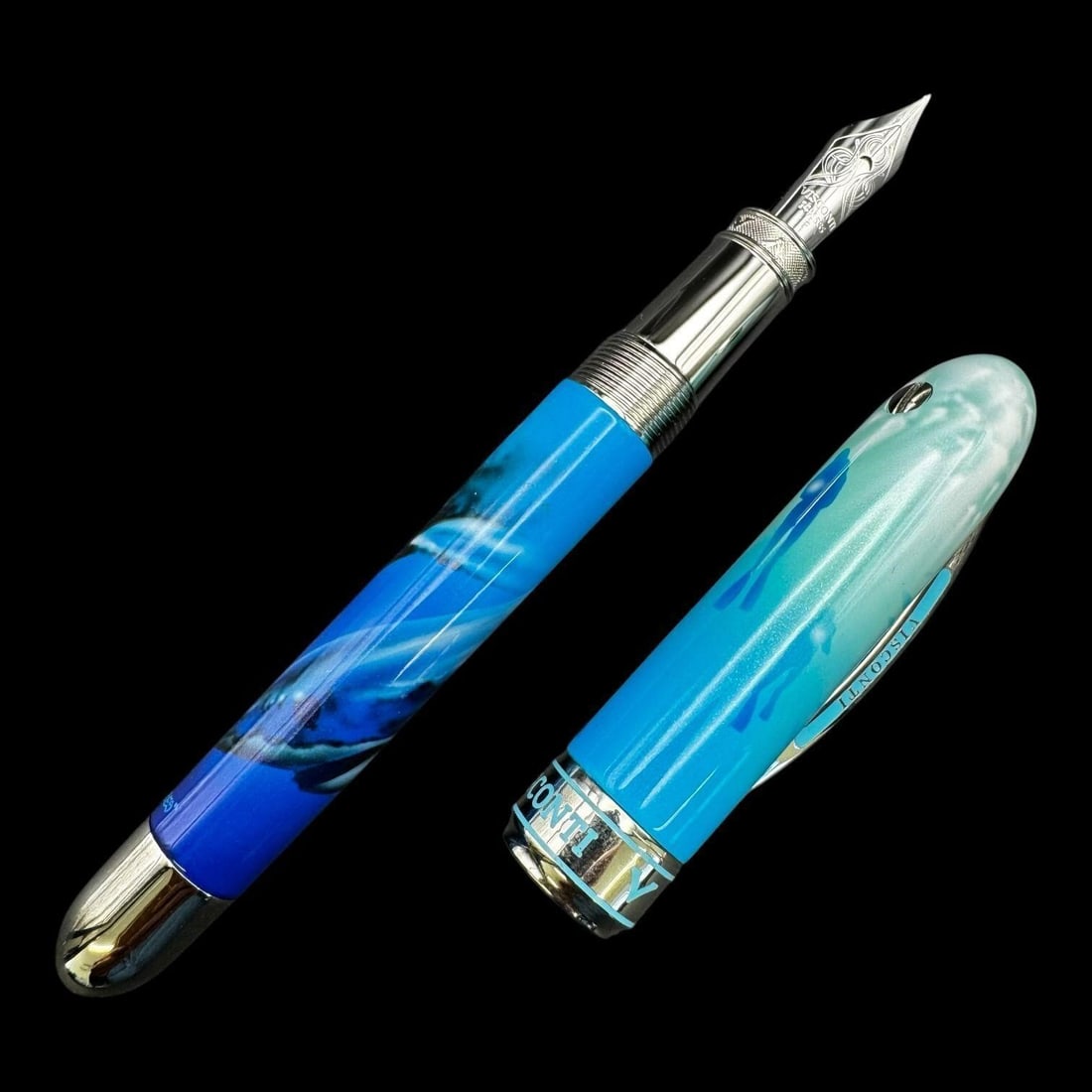 Visconti 14K "Blue Shark" Fountain Pen: Limited edition Visconti fountain pen featuring a striking ocean-inspired blue resin body with shark imagery integrated into the design. The pen is fitted with a Visconti 14K gold nib marked "14K 585