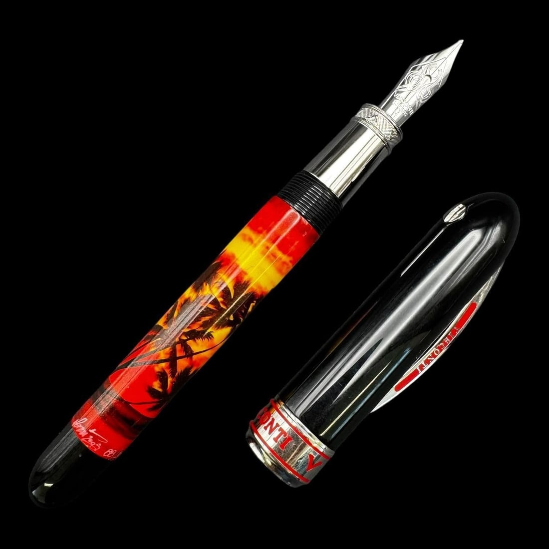 Visconti 14k Limited Edition Fountain Pen: Limited edition Visconti fountain pen dated 2005 featuring a vivid sunset design with palm tree silhouettes across the barrel in rich red, orange, and yellow tones. The pen is fitted with a Visconti
