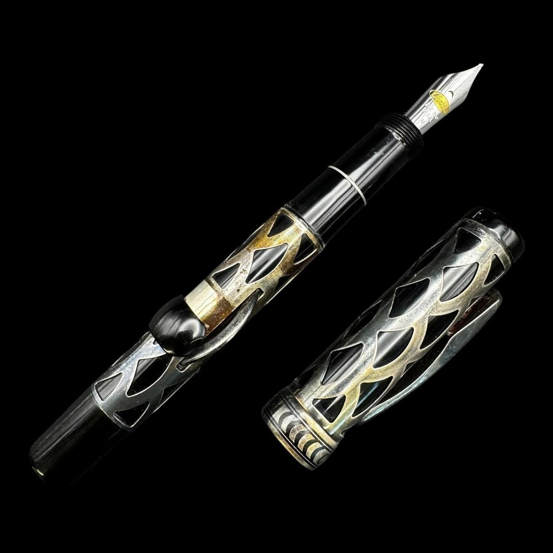 Conklin Filigree Overlay 18k Fountain Pen: Vintage Conklin fountain pen featuring an ornate openwork filigree silver overlay over a dark barrel, marked "Conklin" on the clip and band. The pen is fitted with a Conklin 18K 750 gold nib marked