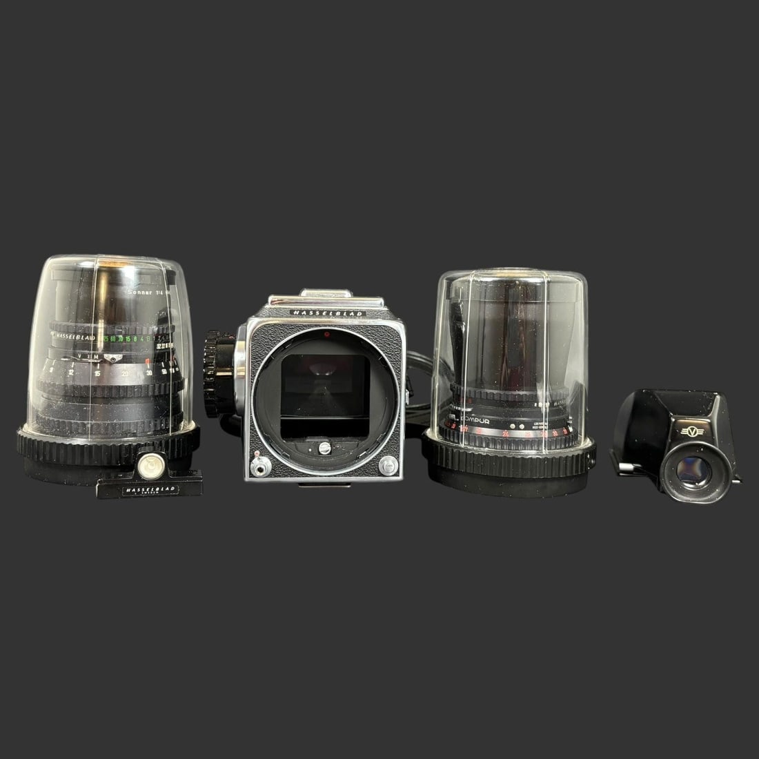 Hasselblad Medium Format Camera Kit & Accessories: Offered here is a classic Hasselblad medium format camera kit, a highly regarded system synonymous with precision engineering and professional photography. This set includes the camera body, a prism v