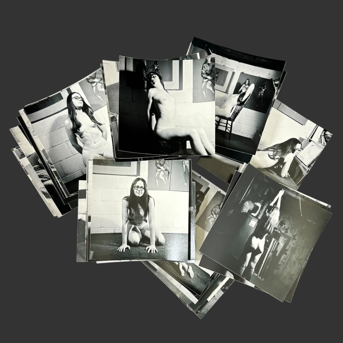 Collection of 48 Reprints of Black & White Nude Photographs: A substantial collection of 48 reprints of black and white nude photographs, featuring a female model posed in a variety of studio and interior settings. The images display a range of artistic composi