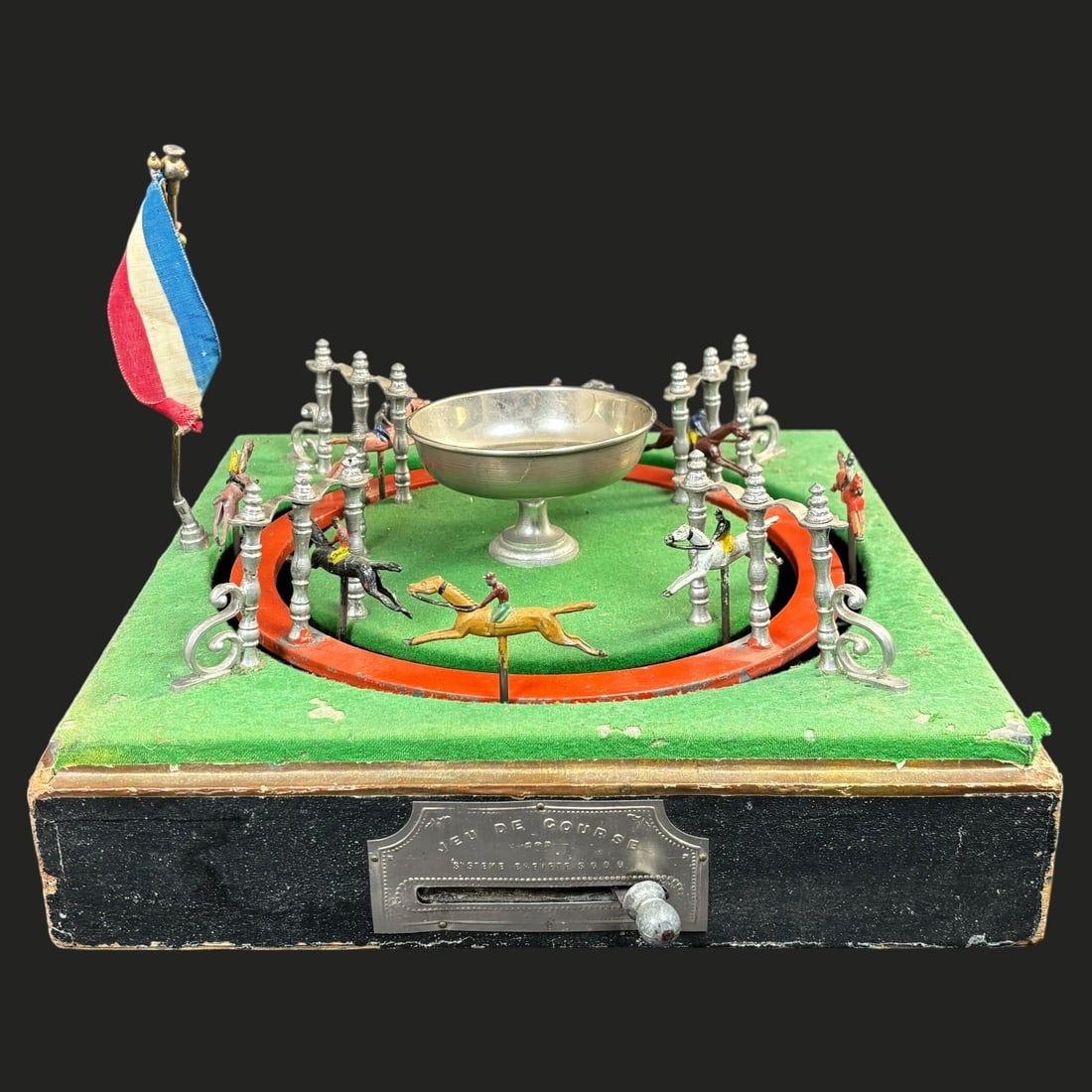 Antique French Jeu de Course Horse Racing Game with Original Case: An engaging antique French “Jeu de Course” mechanical horse racing game, likely dating to the late 19th or early 20th century, housed in its original black fitted case with a sliding front