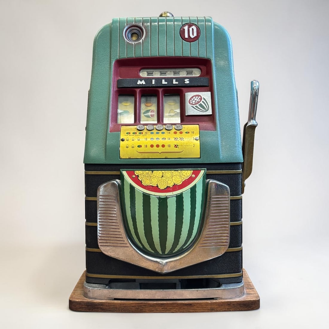 Mills Novelty Co. 10-Cent Watermelon Slot Machine: Wonderful vintage Mills Novelty Co. 10-cent slot machine featuring a striking turquoise and burgundy case, fruit reel windows, original-style payout card, chrome side handle, and the highly desirable 