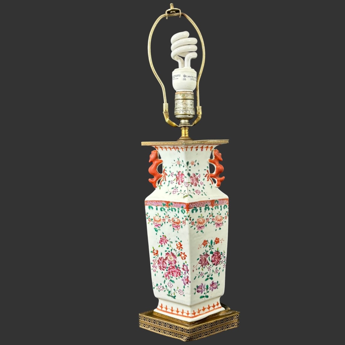 Chinese Famille Rose Porcelain Hexagonal Table Lamp: A striking Chinese porcelain table lamp featuring a finely potted hexagonal body decorated in vibrant famille rose enamels. The surface is adorned with delicate floral sprays in pink, iron red, and gr