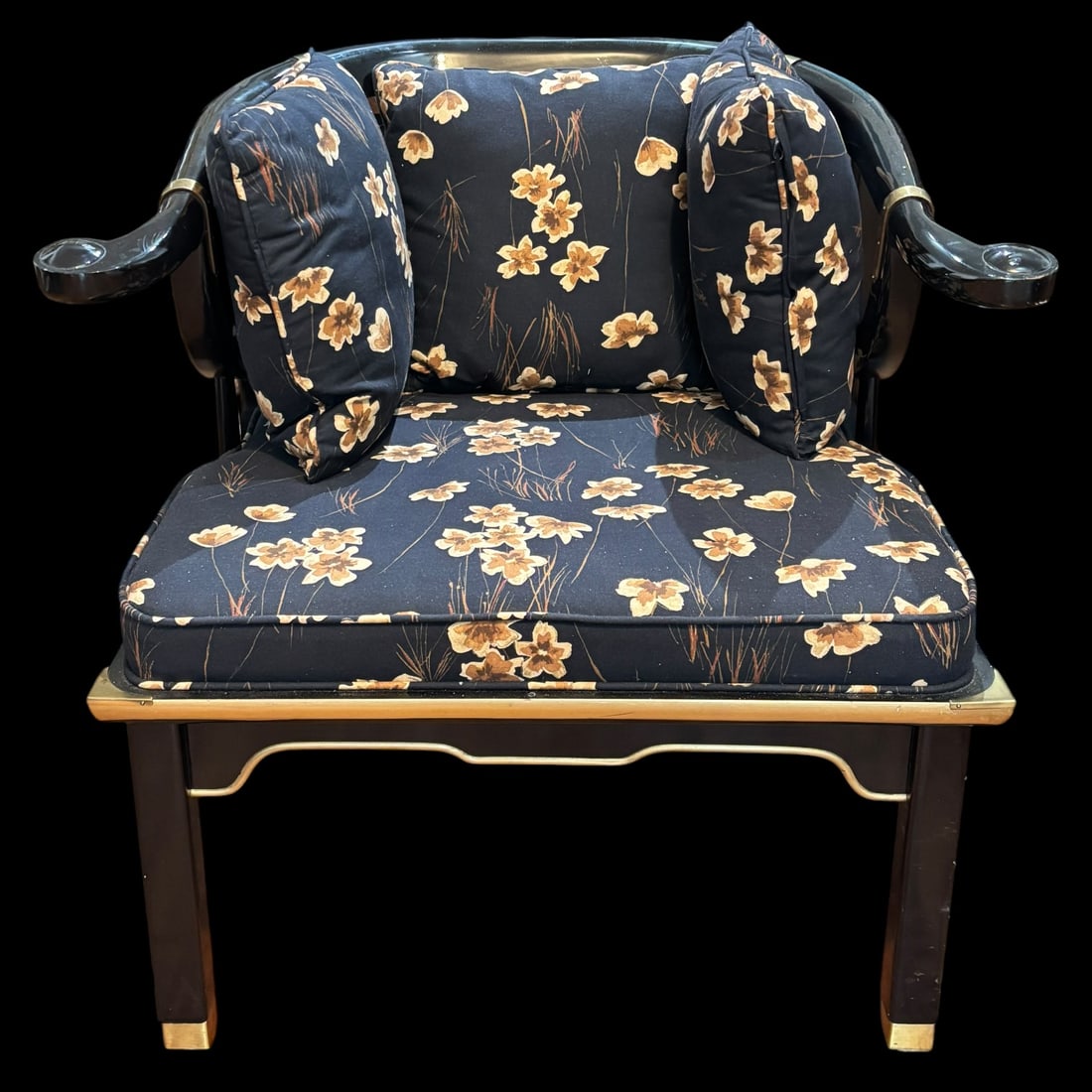 Black Lacquer Chinoiserie Style Armchair with Brass Accents & Floral Cushions: This striking chinoiserie style armchair features a glossy black lacquered wood frame with elegant curved arms, shaped apron details, and warm brass-tone accents throughout, including caps, trim, and 