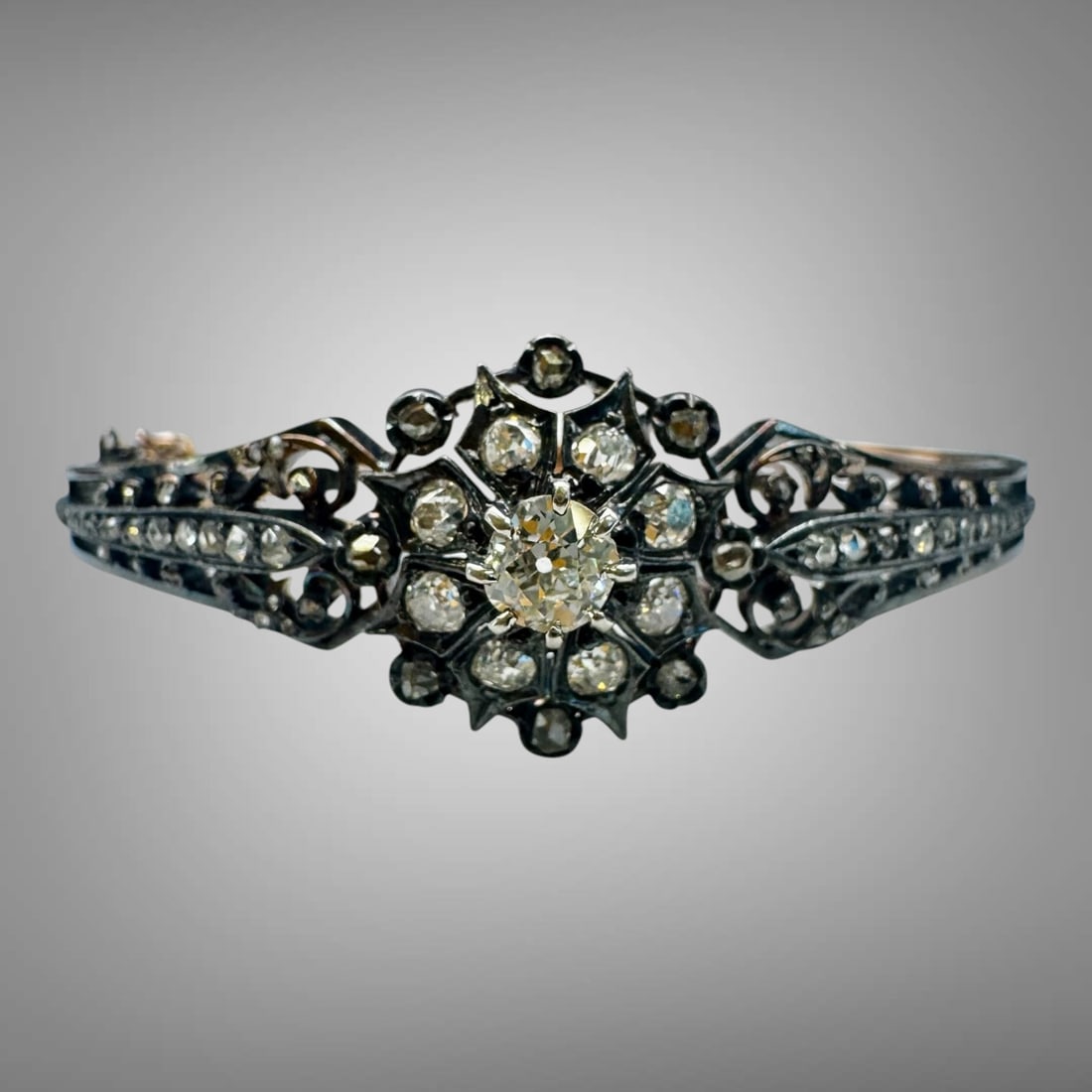 Antique Diamond Bracelet Silver-Topped 14k Gold Cluster Bangle: An elegant antique Victorian diamond bracelet crafted in silver and gold, showcasing exquisite period workmanship and romantic floral design. Top of the bracelet is Sterling silver; bottom is com
