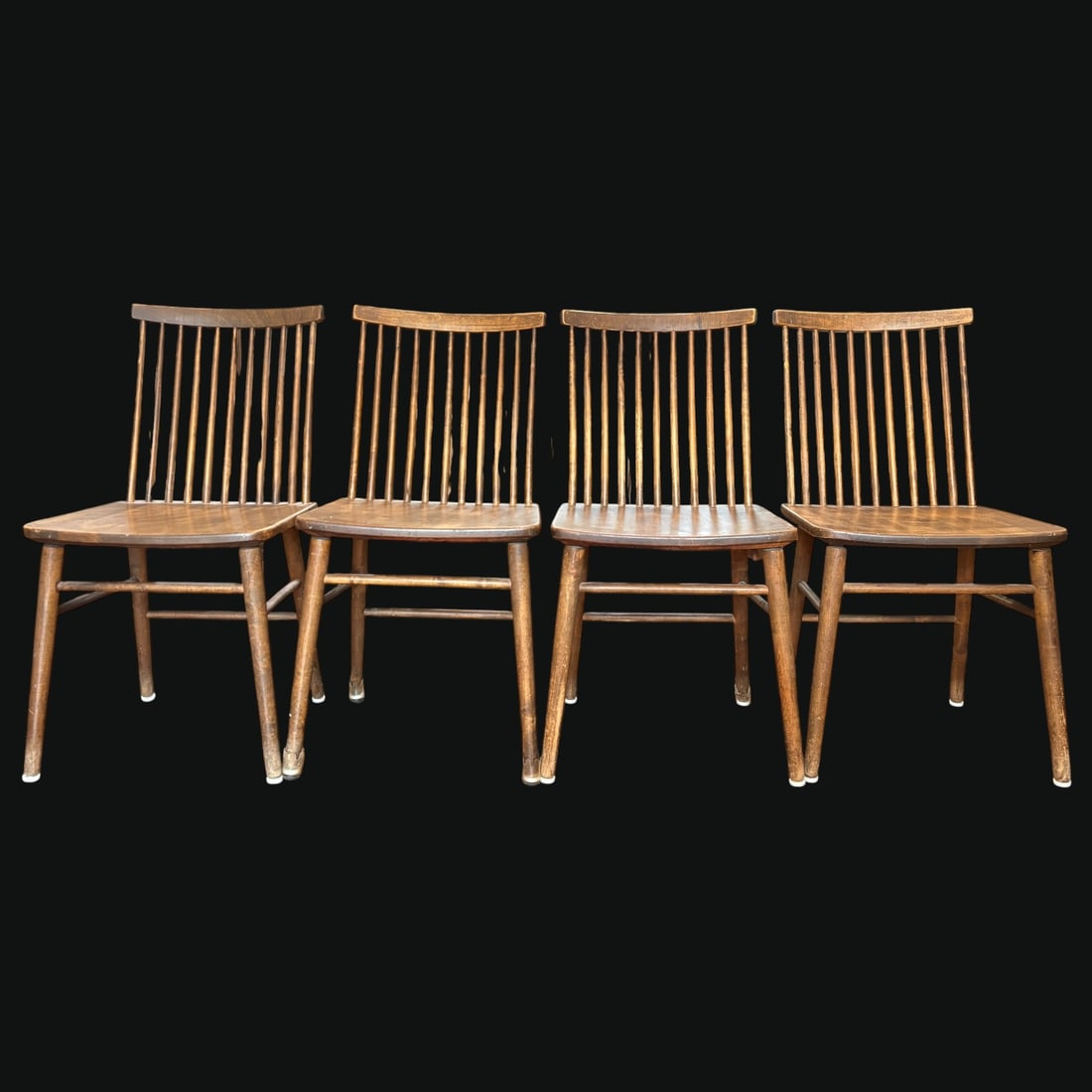 Set of Four MCM Modern Haga Fors Sweden Spindle-Back Dining Chairs: A charming set of four mid-century modern wooden dining chairs by Haga Fors of Sweden, featuring tall spindle backs, gently curved crest rails, shaped seats, splayed tapered legs, and stretcher suppor