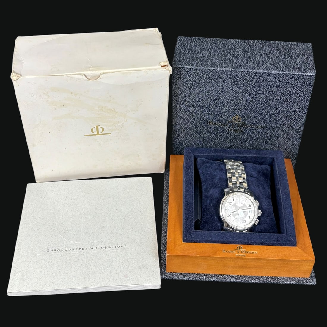 Baume & Mercier Capeland Automatic Chronograph Stainless Steel Watch: Baume & Mercier Capeland automatic chronograph wristwatch, model MOA06858, in stainless steel with matching stainless steel bracelet and deployant clasp. The watch features a silver-tone dial with
