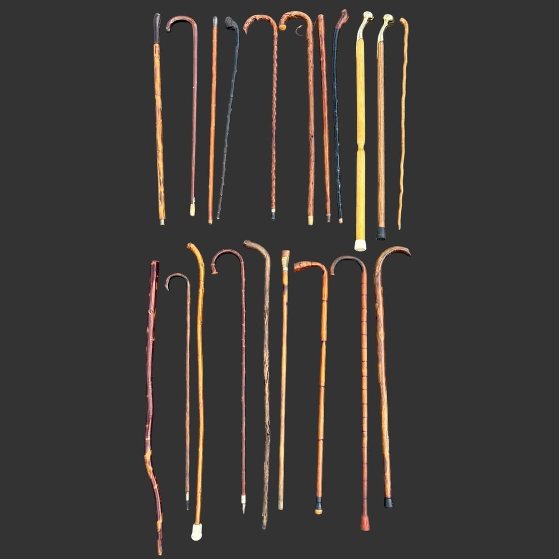 Collection of Antique Walking Sticks and Canes: Offered here is a varied collection of 22 antique and vintage walking sticks and canes, featuring an appealing mix of materials, forms, and finishes. The group includes crook-handle examples, rustic n