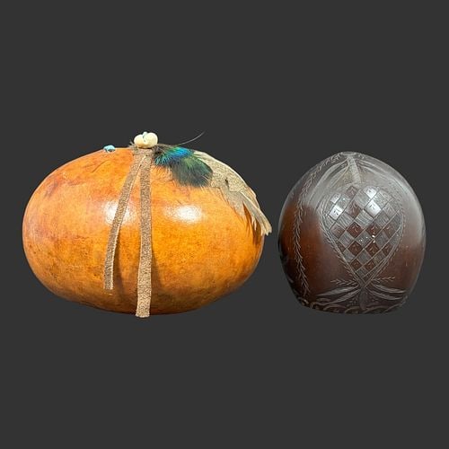 Two Native American Decorated Gourd Vessels: Lot of two Native American decorated gourd vessels, including a large rounded example embellished around the opening with turquoise inlays, a cowrie shell, feathers, and long hide ties, together with 