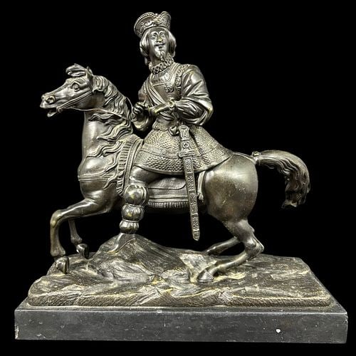 Patinated Metal Equestrian Figure of a Renaissance Nobleman: Decorative patinated metal sculpture depicting a Renaissance-style nobleman or cavalier mounted on a rearing horse, the rider modeled with plumed cap, beard, ornate costume, sword, and reins. The hors