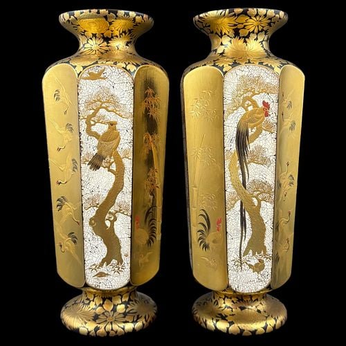 Pair of Japanese Gilt Black Lacquer Hexagonal Vases w/ Bird Floral Panels: A striking pair of Japanese decorative vases featuring tall hexagonal bodies with flared rims and raised pedestal bases, richly decorated in gilt and black lacquer tones. Each vase is ornamented with 
