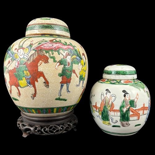 Pair of Chinese Famille Verte Porcelain Ginger Jars w/ Figural Decoration: Offering a decorative pair of Chinese famille verte porcelain ginger jars, including a larger crackle-glazed jar with lid and carved wooden stand, decorated with colorful warrior and equestrian figure