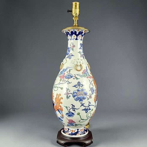 Chinese Porcelain Vase Table Lamp with Foo Lion Mask Ring Handles: Decorative porcelain vase-form table lamp with a colorful Chinese style design featuring painted foo lion, floral, scrolling vine, and ribbon motifs in blue, orange, green, pink, and gilt accents. The