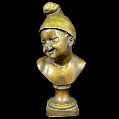 Enrico Cassi (Italy, 1863 – 1913) Patinated Bronze Bust of Smiling Child: Charming patinated bronze bust depicting a smiling young child wearing a cap, raised on a turned socle and stepped square base. The sculpture is signed “E. Cassi” to the front of the base 